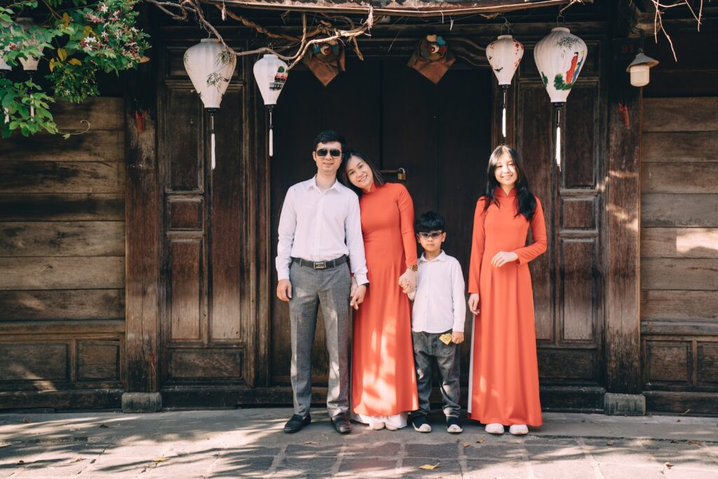 a group of people posing for a photo in front of a wood door