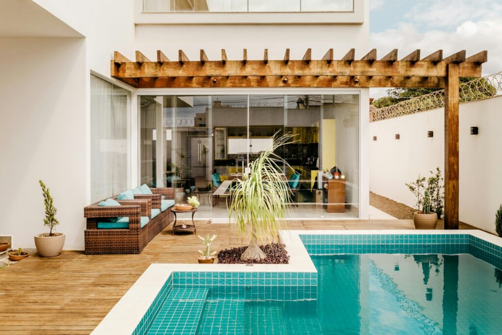 brown wooden table near swimming pool